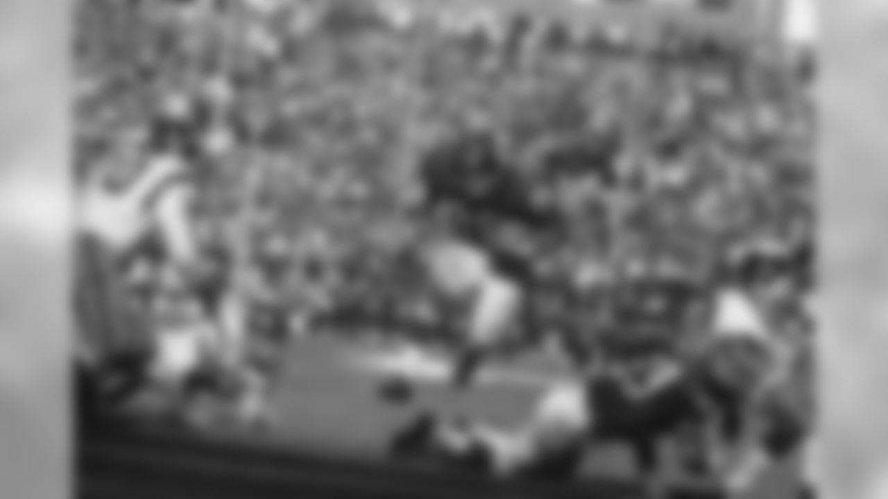 Fullback Chuck Mercein of the New York Giants, 29, carries ball through what seems to be a wide opening in third quarter at New York's Yankee Stadium on Oct. 16, 1966. This play ended in no gain as Gregg Larson, 53, goes down and Washington Redskins back Sam Huff, 70, moves in to make the tackle. Other identifiable Redskin is end Carl Kammerer, 66. Giants took the game, 13-10. (AP Photo)