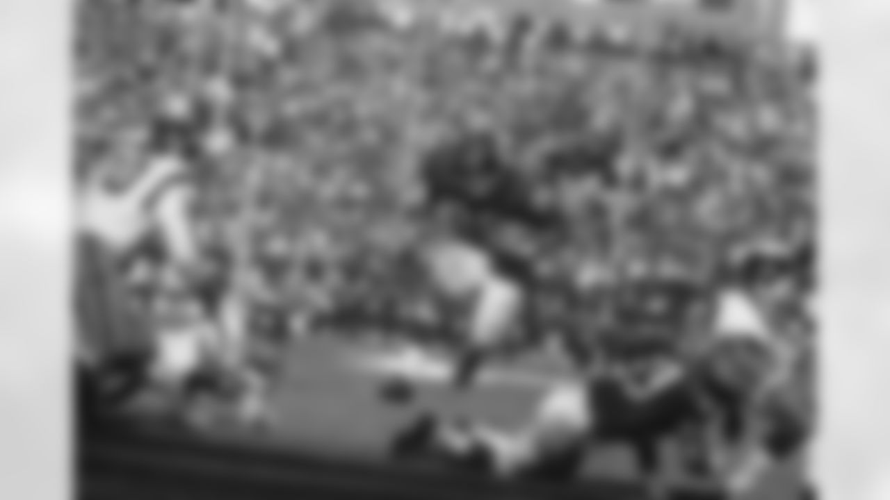 Fullback Chuck Mercein of the New York Giants, 29, carries ball through what seems to be a wide opening in third quarter at New York's Yankee Stadium on Oct. 16, 1966. This play ended in no gain as Gregg Larson, 53, goes down and Washington Redskins back Sam Huff, 70, moves in to make the tackle. Other identifiable Redskin is end Carl Kammerer, 66. Giants took the game, 13-10. (AP Photo)