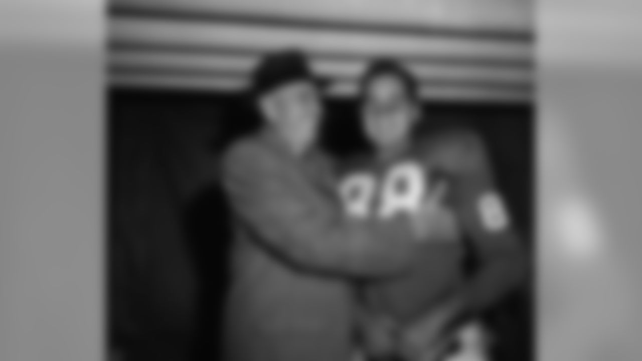 New York Giant coach Jim Lee Howell hugs Allen Pat Summerall in dressing room of Yankee Stadium after Giants defeated Baltimore Colts 24-21 in New York on Nov. 9, 1958. Summerall, with less than 3 minutes to play in game kicked 28-yard field goal to provide winning margin in the game. He also kicked all three points after touchdown for the Giants. The New York team, with season record of 5-2, moved into first place tie with Cleveland Browns in Eastern Division of National Football League. (AP Photo)