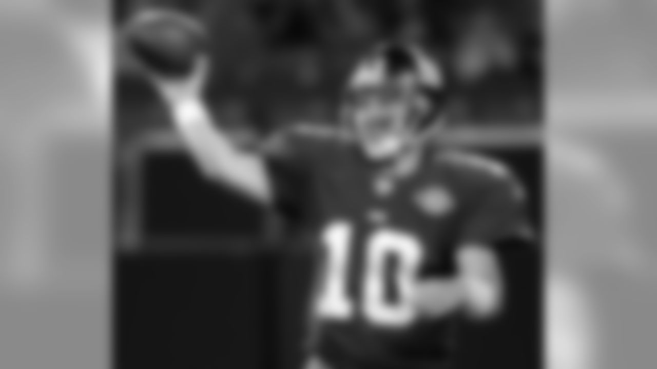 New York Giants quarterback Eli Manning passes the ball during the third quarter against the Kansas City Chiefs Friday night, August 13, 2004, at Giants Stadium in East Rutherford. (AP Photo/Bill Kostroun)