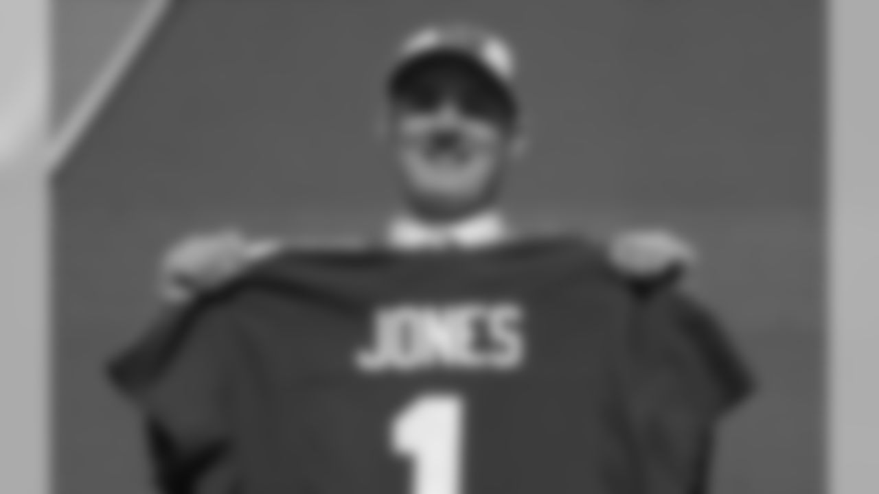 Duke quarterback Daniel Jones poses with his new jersey after the New York Giants selected Jones in the first round at the NFL football draft, Thursday, April 25, 2019, in Nashville, Tenn. (AP Photo/Mark Humphrey)
