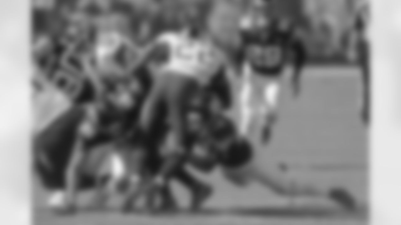Jacksonville Jaguars defensive end Adam Gotsis (96) and safety Andrew Wingard (42) tackle Tennessee Titans running back Derrick Henry (22) for no gain in the fourth quarter during an NFL football game, Sunday, September 20, 2020 in Nashville, Tn.