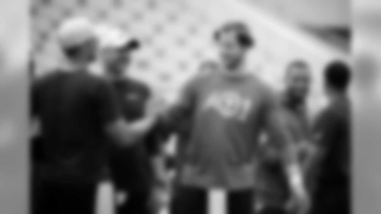 Philadelphia Eagles quarterback Carson Wentz, center, greets Jacksonville Jaguars quarterback Nick Foles, left, during warms up before the start of an NFL preseason football game, Thursday, Aug. 15, 2019, in Jacksonville, Fla. (AP Photo/Stephen B. Morton)