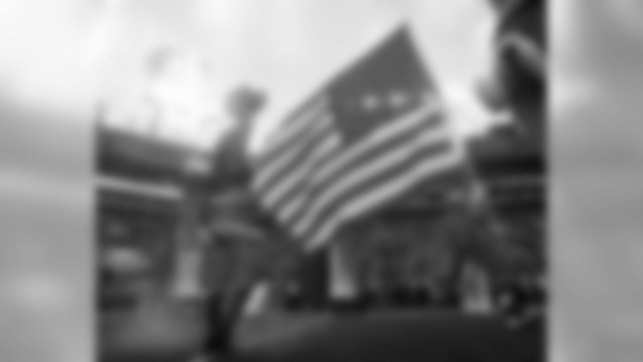 Tampa Bay Buccaneers tackle Leonard Wester (66) carries the American Flag to the field before play against the New Orleans Saints in a week 14 NFL football game Dec. 11, 2016 in Tampa, Fla. The Buccaneers won 16 - 11. (Al Messerschmidt via AP)