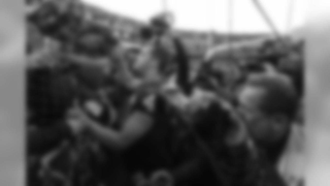 Oakland Raiders quarterback Derek Carr is greeted by fans in "The Black Hole" after an NFL football game against the Jacksonville Jaguars in Oakland, Calif., Sunday, Dec. 15, 2019. Jacksonville won the game 20-16. (AP Photo/D. Ross Cameron)