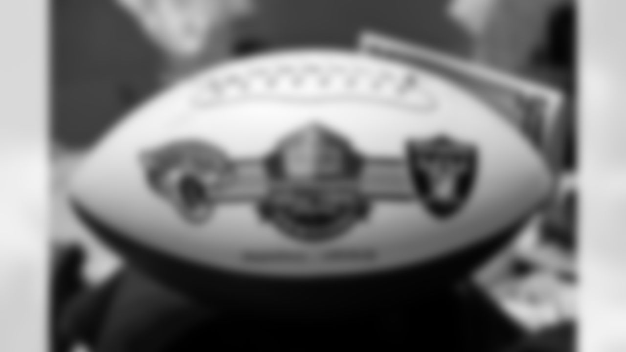 This is a commemorative football is the centerpiece of a table setting for the Pro Football Hall of Fame Class of 2022, enshrinees' roundtable in Canton, Ohio, Sunday, Aug. 7, 2022. (AP Photo/Gene J. Puskar)