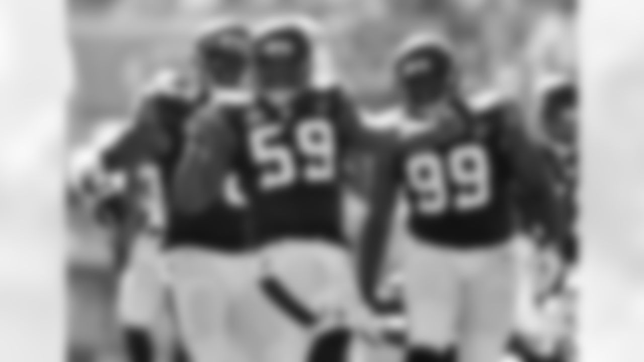 The defensive line celebrated a sack against the Dolphins.