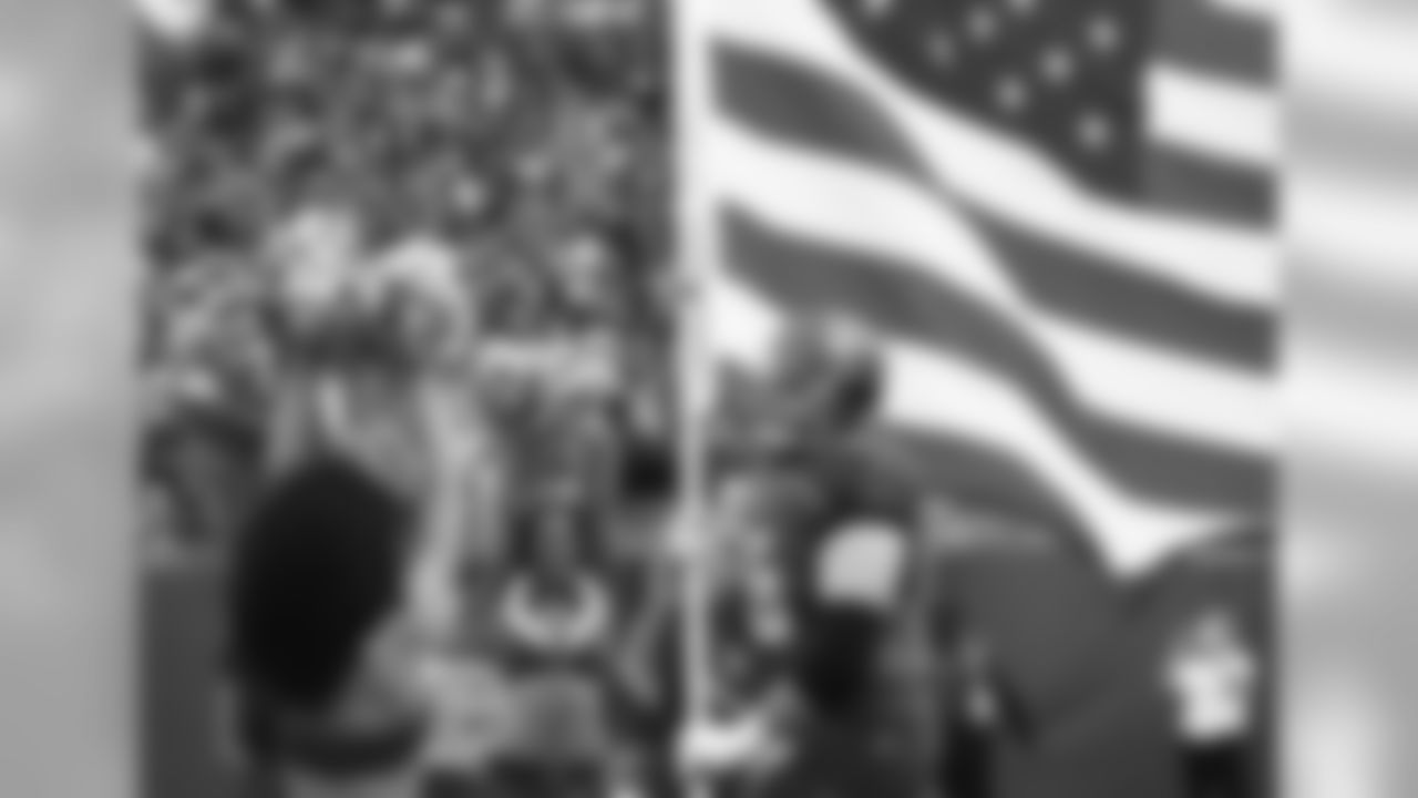 Tampa Bay Buccaneers tackle Leonard Wester (66) carries the American Flag to the field before play against the New Orleans Saints in a week 14 NFL football game Dec. 11, 2016 in Tampa, Fla. The Buccaneers won 16 - 11. (Al Messerschmidt via AP)