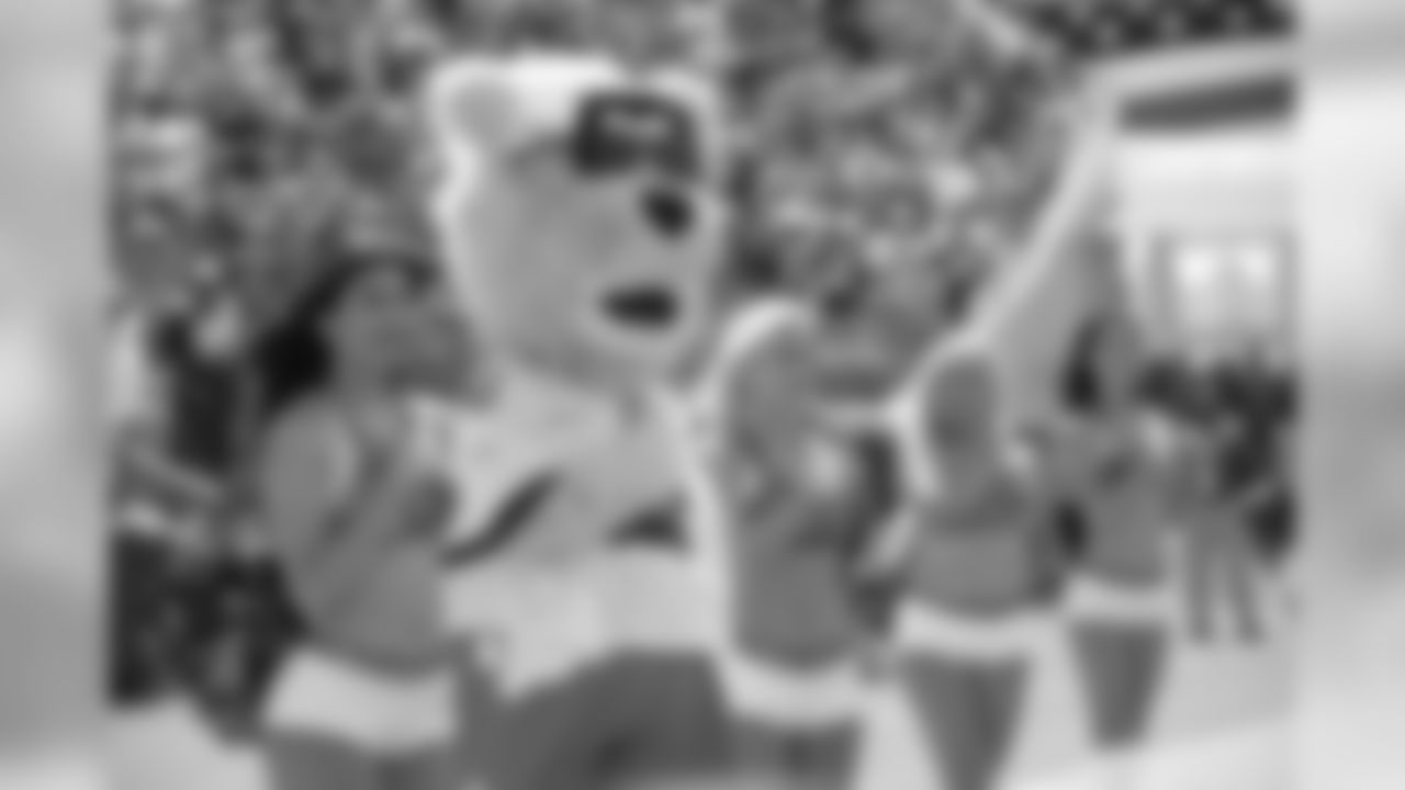 The Jacksonville Jaguars mascot Jaxson de Ville, second from left, stands with cheerleaders on the sideline during singing of the national anthem before an NFL football game against the Tennessee Titans Sunday, Sept. 23, 2018, in Jacksonville, Fla. (AP Photo/Phelan M. Ebenhack)