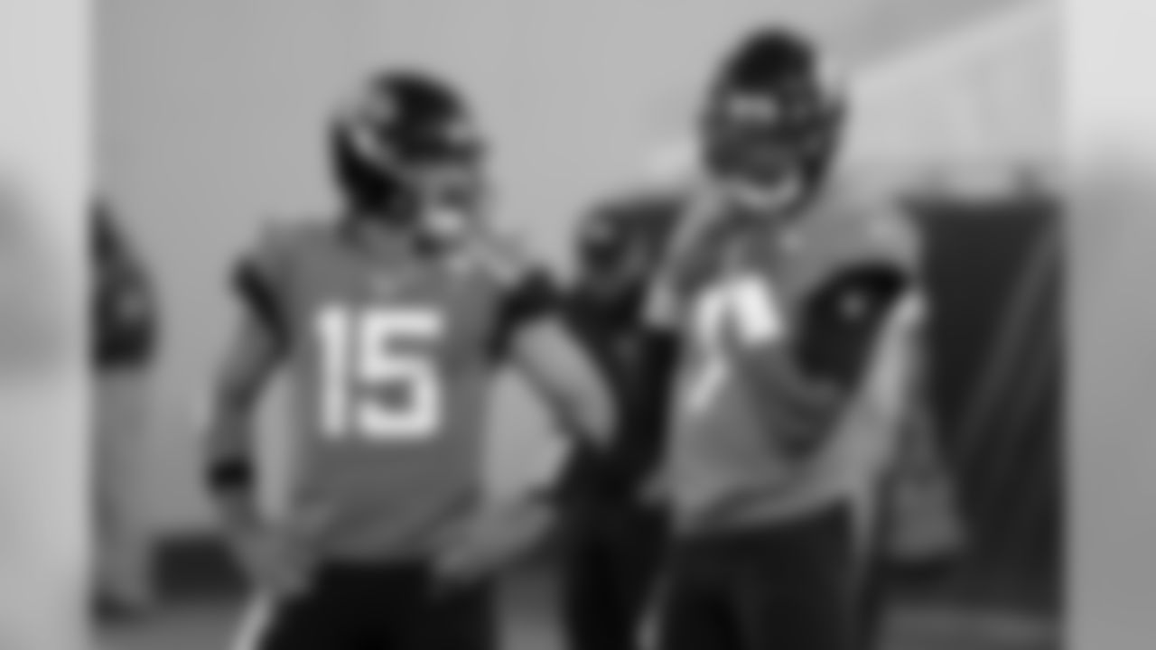 Jacksonville Jaguars quarterback Gardner Minshew (15) and quarterback Joshua Dobbs (1) talk during warm ups before an NFL football game against the Tennessee Titans, Thursday, Sept. 19, 2019, in Jacksonville, Fla. (AP Photo/John Raoux)