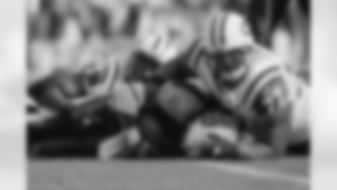The 195-pound RB Chris Johnson waits for the 335-pound DT Kris Jenkins (No. 77) to get up in that same Nov. 23 game.