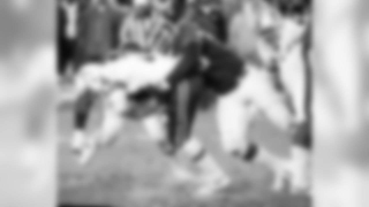 New England Patriots quarterback Steve Grogan is dropped behind the line of scrimmage by New York Jets Lawrence Pillers, right, in the fourth quarter of their game at Shea Stadium in New York, Dec. 10, 1979. Jets quashed Pats playoff hopes, 27-16. (AP Photo/Ray Stubblebine)