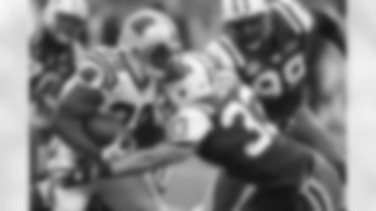 RB Johnathan Stewart's momentum is brought to an immediate halt as S Eric Smith wraps him up for a tackle in our 11/29/09 win.