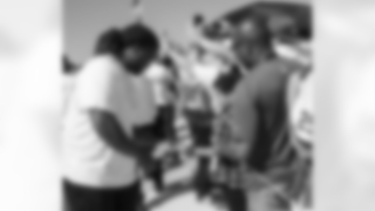 While along the Jets Runway, NT Damon "Snacks" Harrison stopped to entertain a young fan before rejoining his teammates and proceeded to enter the stadium. Jets players and coaches walk through the fans at 10:30 a.m. before the game.