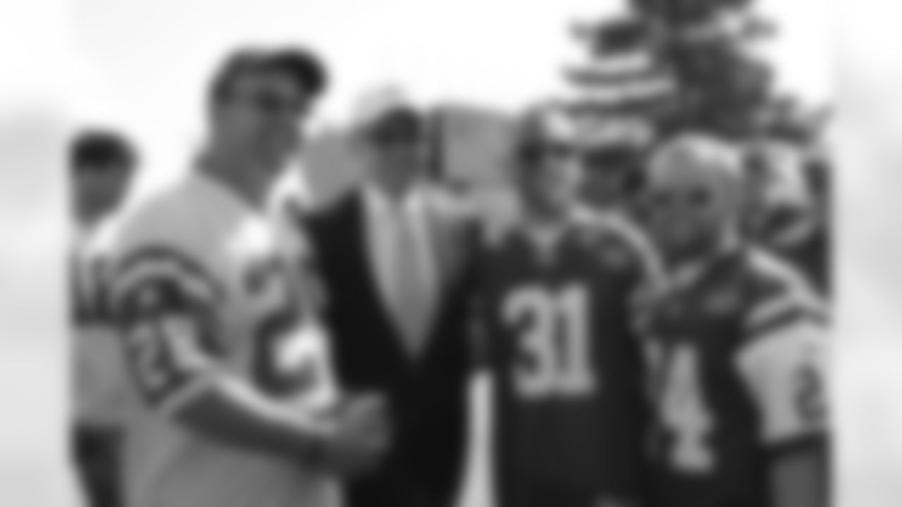 Chairman & CEO Woody Johnson poses for a picture with a few fans tailgating before the game.