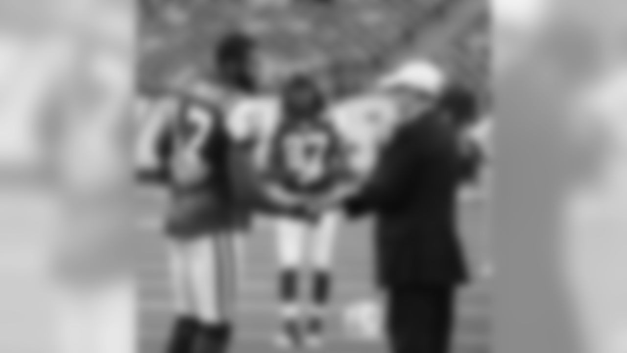 New York Jets' Braylon Edwards, left, greets team owner Woody Johnson before the Jets preseason football game against the Washington Redskins at New Meadowlands Stadium in East Rutherford, N.J., Friday, Aug. 27, 2010. (AP Photo/Bill Kostroun)