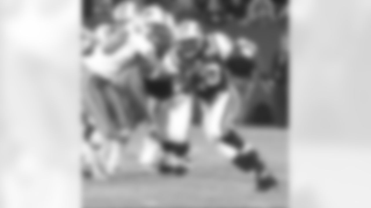 One Hall of Famer (No. 28 Curtis Martin) runs by another potential HOF player (No. 99 Jason Taylor) during a Sunday Night Football game, a 13-10 Jets win on 11/10/02.