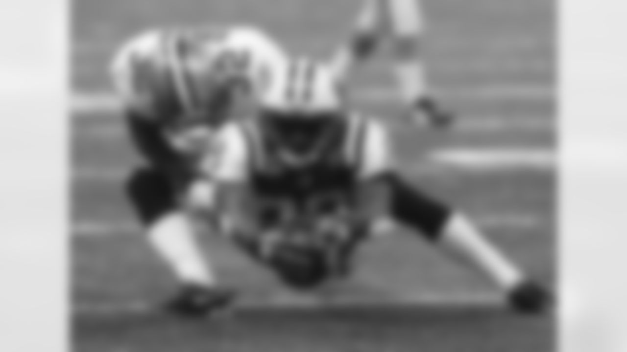 Diving through the legs of CB Jabari Greer, WR Jerricho Cotchery stretches for a first down during the 24-10 loss to the Saints at the Superdome.