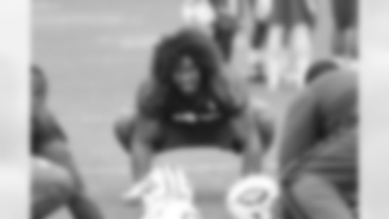 DL Leonard Williams stretches before practice