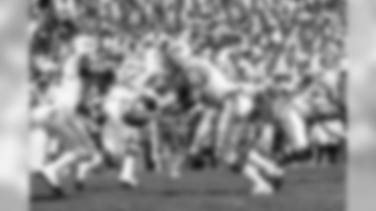 Joe Namath hands off to John Riggins (44) during second period action in the Yale-United Way NFL preseason game between the Jets and Giants at the Yale Bowl in New Haven, CT. Also photographed is Emerson Boozer of the Jets (32).