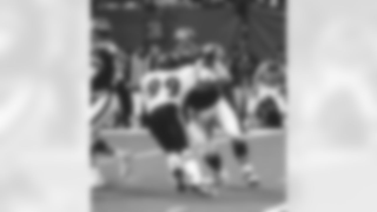 T John "Jumbo" Elliot gives his quarterback time as he holds off Michael Mc