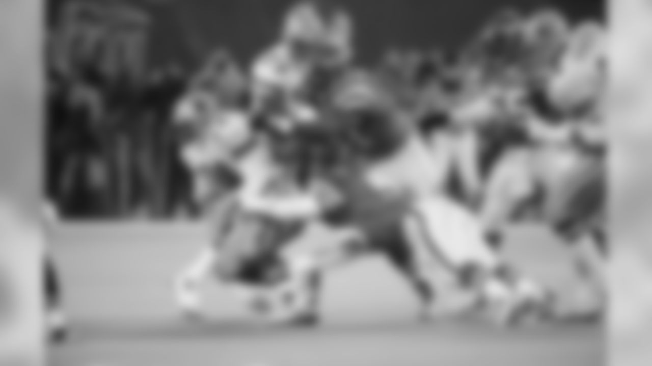 New York Jets Marvin Washington, upper right, and Kyle Clifton, lower right, keep Dallas cowboys Emmitt Smith (22) to a 3-yard gain during the first quarter of their game at Giants Stadium in East Rutherford, N.J. on Saturday, Dec. 18, 1993. Cowboys Erik Williams (79) looks on. (AP Photo/Bill Kostroun)