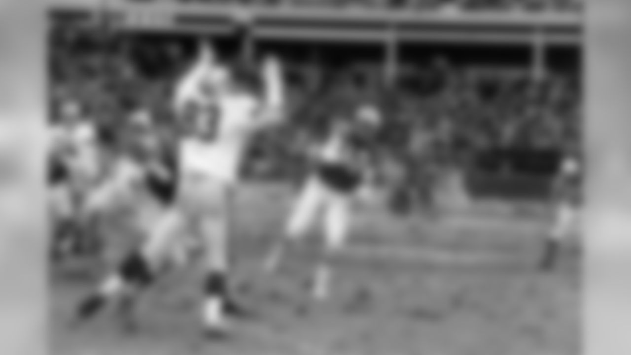 New York Jets quarterback Joe Namath gets a pass off in the first quater of the AFL championship game as Oakland Raider Ben Davidson (83) attempts to knock the pass down at Shea Stadium in New York City on Dec. 29, 1968. Namath threw three touchdown passes en route to a 27-23 win over the Raiders. (AP Photo)