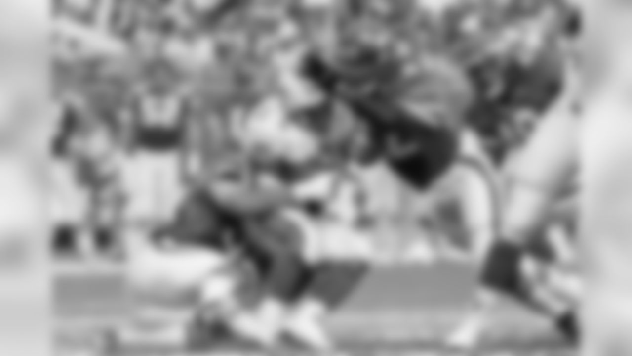 New York Jets Ronnie Lott (42), right, and Jeff Lageman (56) bring down Miami Dolphins Mark Higgs (21), center, during first half action at Joe Robbie Stadium in Miami , Sept. 12, 1993. (AP Photo/Hans Deryk)