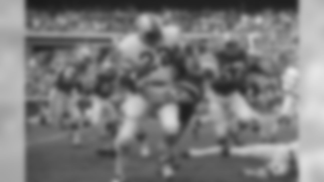 Boston Patriot Sid Blanks (22) is tackled by New York Jet Mike Battle while running back the first period kickoff during game at Shea Stadium, Sunday Nov. 23, 1970, New York. Jets won a 17-3 victory. The rest of the players are unidentified. (AP Photo/Harry Harris)