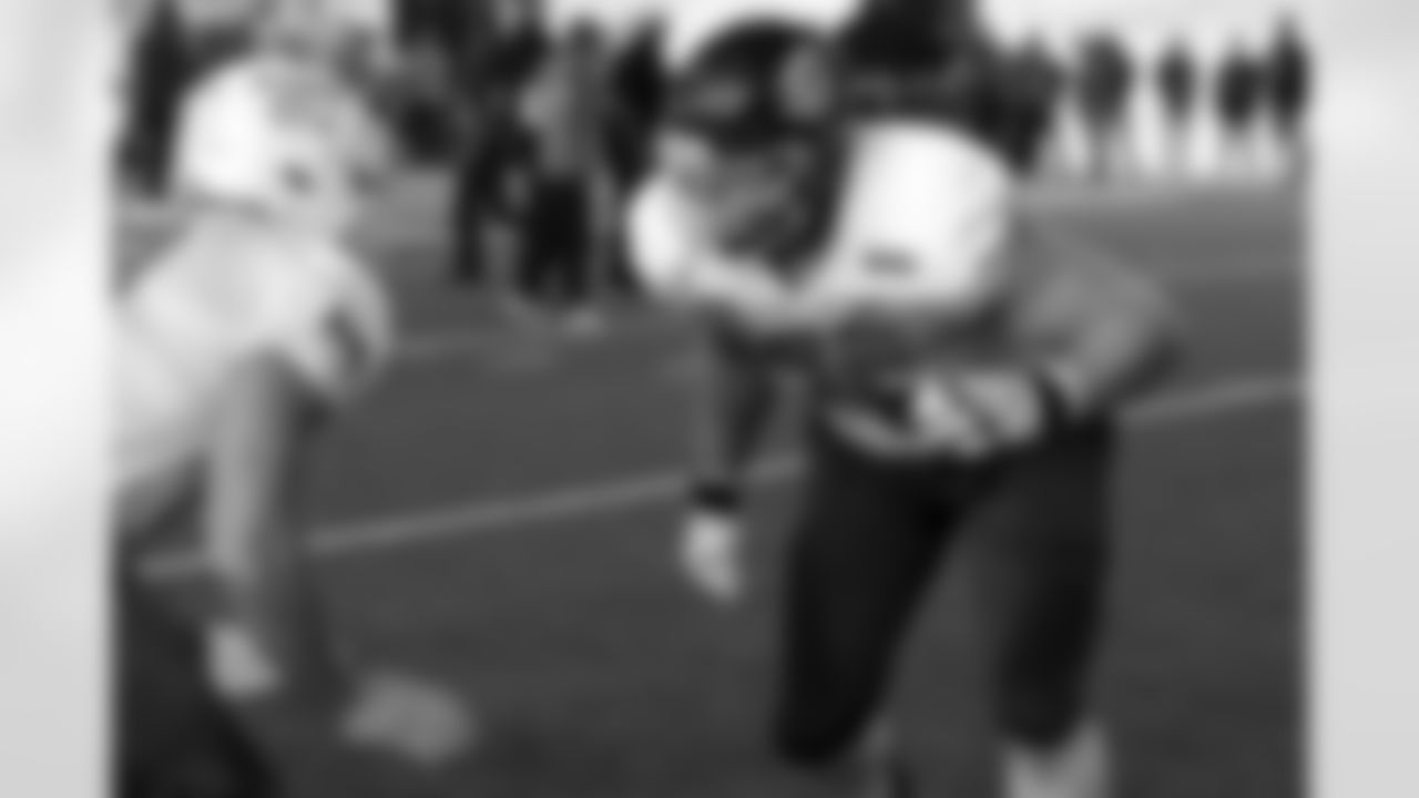 National Team offensive lineman Cole Strange of UT-Chattanooga and offensive lineman Bernhard Raimann of Central Michigan run through drills during practice for the Senior Bowl NCAA college football game Thursday, Feb. 3, 2022, in Mobile, Ala. (AP Photo/Butch Dill)
