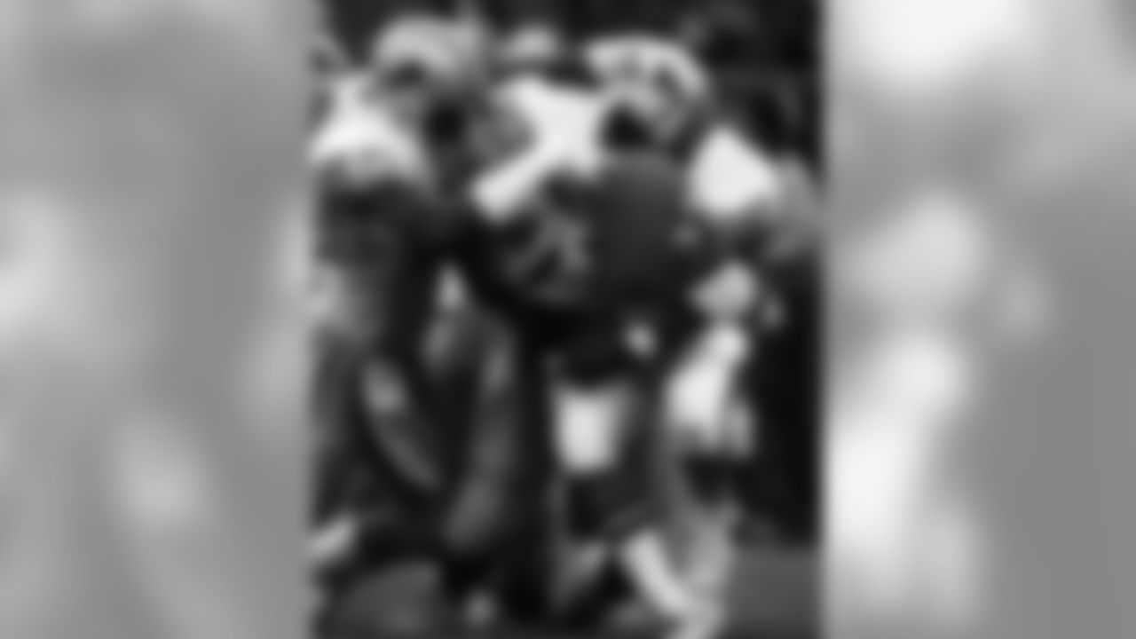 Detroit Lions defensive end Reggie Rogers (60) and defensive tackle Jerry Ball (93) team up to stop Denver Broncos running back Sammy Winder (23) during an NFL game in Denver, Colo., Nov. 1, 1987. The Broncos shutout the Lions 34-0. (AP Photo/Damian Strohmeyer)