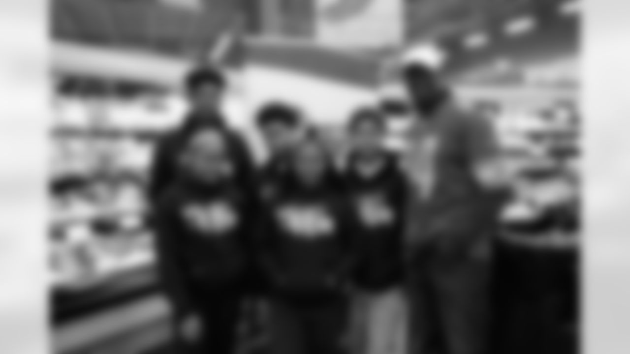 Students from Detroit Lions Academy with former Detroit Lions wide receiver Herman Moore (84) at Fuel Up to Play60 at Parkway Foods on Wednesday, March 27, 2019 in Detroit.