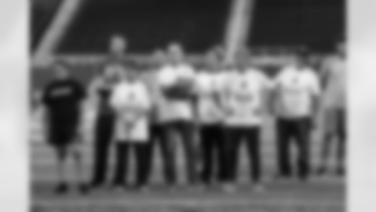 Detroit Legend Eric Stocz with United States veterans and service members gathered at Ford Field for a football clinic. A Detroit Lions Salute to Service initiative presented by Humanetics.