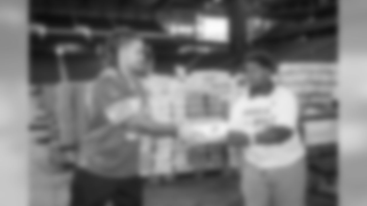 Detroit Lions cornerback Mike Ford (38) helps pack Kroger food boxes with students from Detroit Lions Academy Tuesday, Oct. 8, 2019 in Detroit.
