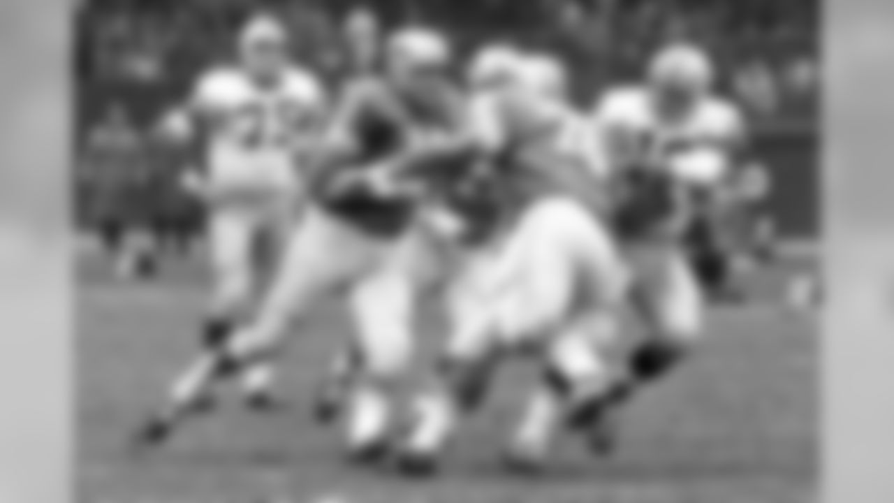 In this Nov. 23, 1962, file photo, Detroit Lions defensemen Darris McCord (78) and Roger Brown (76) tackle Green Bay Packers quarterback quarterback Bart Starr (15) in the backfield as Packers offensive tackle Forrest Gregg (75) looks on during an NFL football game in Detroit. (AP Photo/File)
