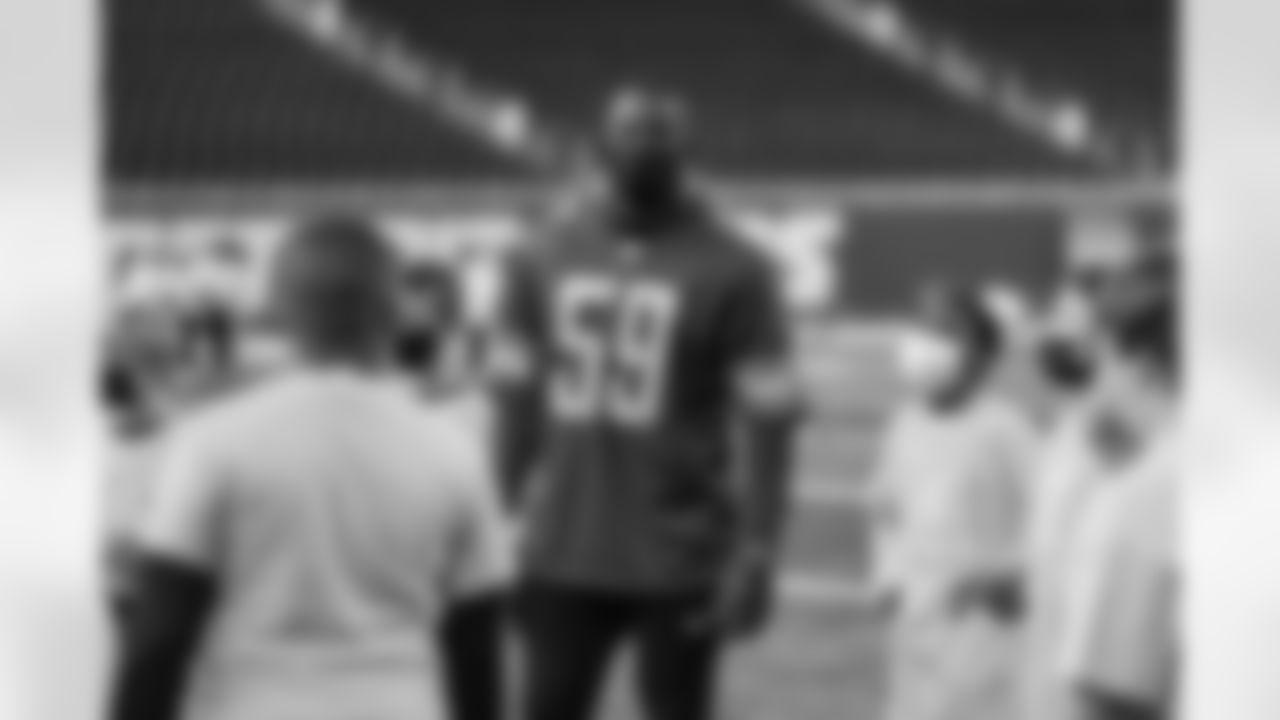 Lions Legend Alex Lewis (59) on the field with youth athletes from Playworks Michigan while participating in a Flag Football Jamboree at Ford Field.