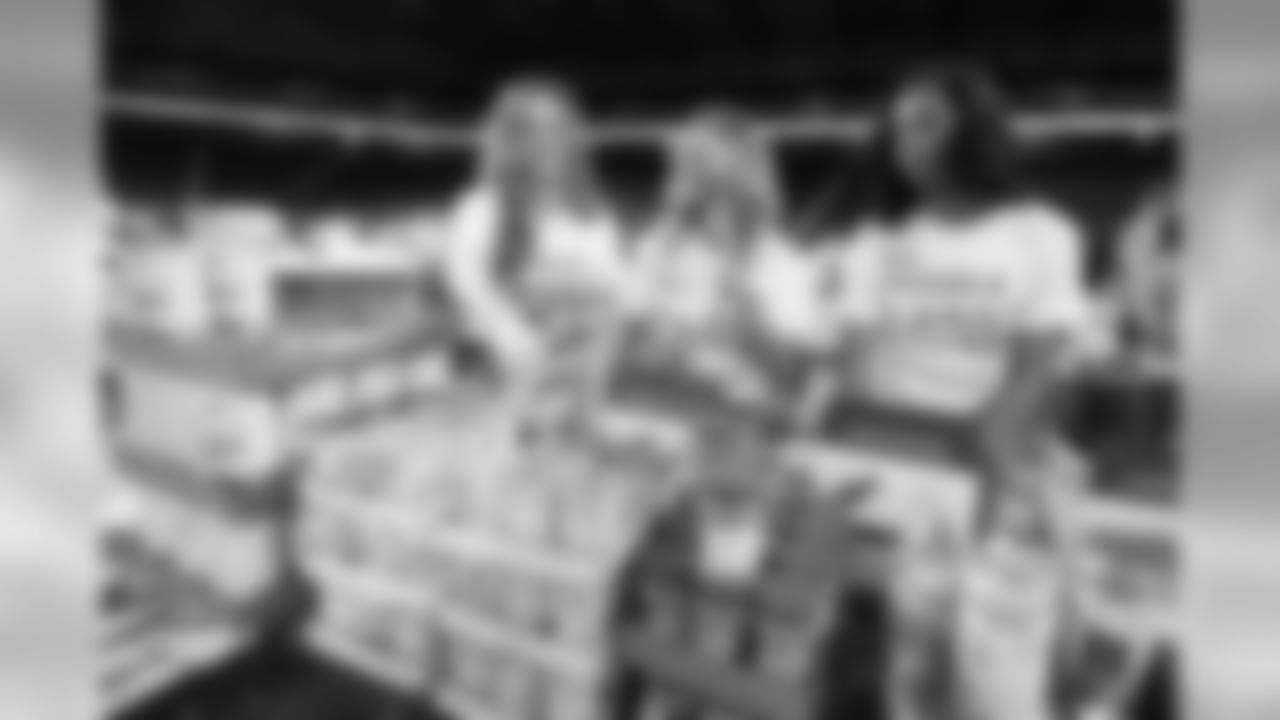 Detroit Lions Cheerleaders help pack boxes of Kroger food products for those in need as part of the Lions Huddle for 100 event Thursday, Oct. 10, 2019 in Detroit (Detroit Lions via AP).