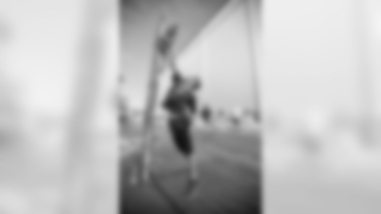 A fan tests out his vertical leap before training camp practice on Thursday, Aug. 2, 2018 in Allen Park, Mich. (Detroit Lions via AP)