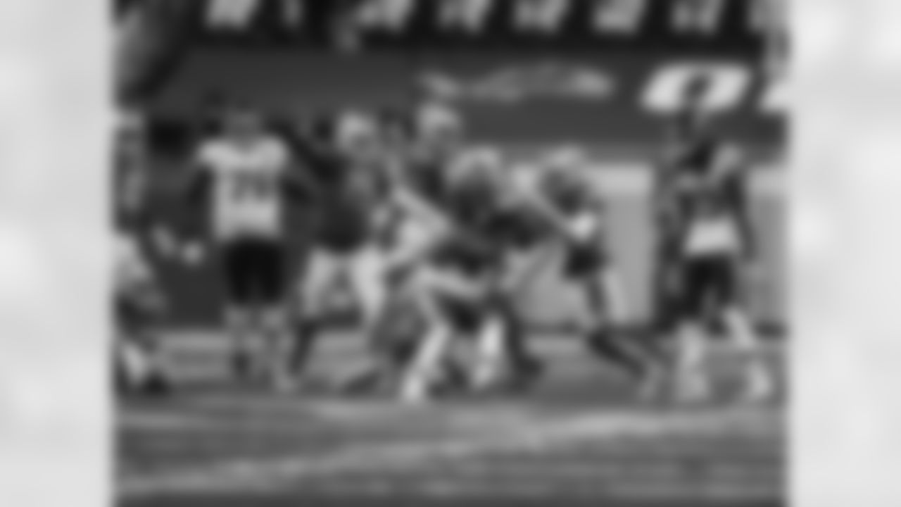 Detroit Lions linebacker Christian Jones (52) and Detroit Lions defensive lineman John Penisini (91) make a tackle during an NFL football game against the Washington football team on Sunday, Nov. 15, 2020 in Detroit. (Detroit Lions via AP).