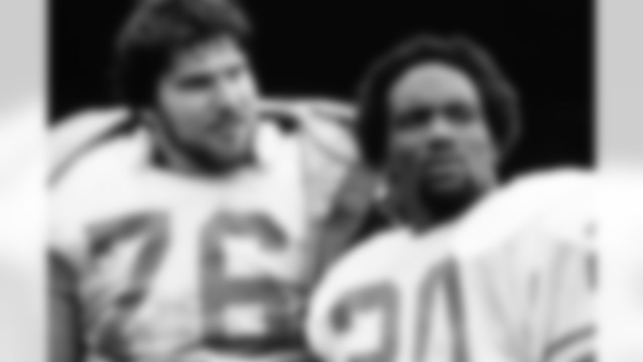 Detroit Lions tackle Karl Baldischwiler (76) and running back Billy Sims (20) watch from the sidelines during an NFL game against the Green Bay Packers in Milwaukee, Sept. 14, 1980. The Lions defeated the Packers 27-9. Baldischwiler and Sims were teammates at Oklahoma. (AP Photo/Vernon Biever)