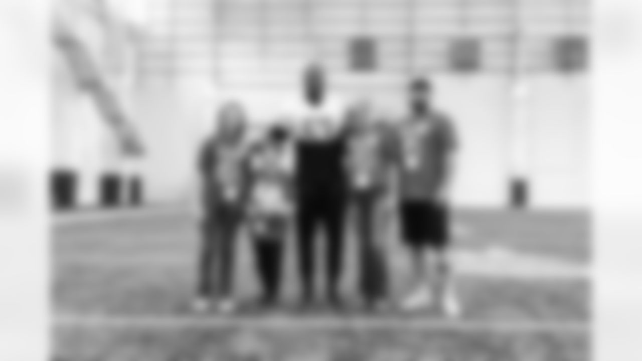 Detroit Lions defensive lineman Charles Harris (53) taking a photo with the TAPS family of fallen hero Jeremiah Kochis during a Saturday walkthrough at the Lions Training Facility in Allen Park, MI on November 5th, 2022. (Joshua Hanford/Detroit Lions).