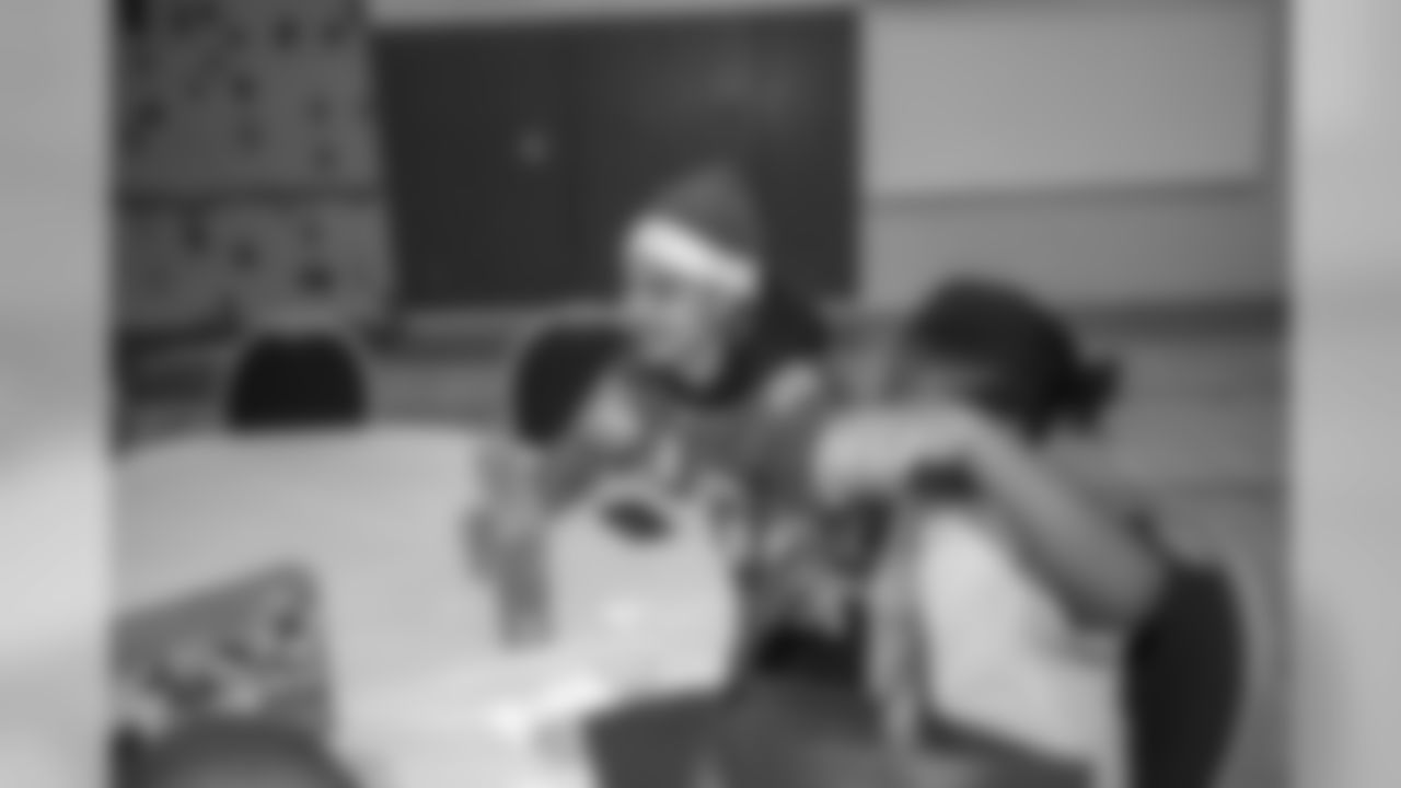 Detroit Lions cornerback Mike Ford (38) distributes gifts to students at Mary McLeod Bethune Elementary-Middle School Tuesday, Dec. 10, 2019 in Detroit.