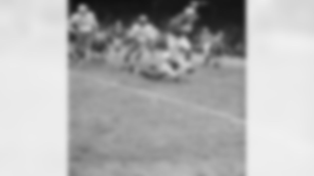 Detroit Lions halfback Dan Lewis (45) looks like he is about to be toppled by Chicago Cardinals back Jim Wagstaff (on ground), but Lewis was too fleet for him. He ran a good ten yards more in this fourth quarter play before another player nailed him. At rear is Cardinals linebacker Ted Bates (51). The Lions scored early and kept a healthy lead throughout the game to win 54-21, on Dec. 7, 1959 in Detroit. (AP Photo/AlvinQuinn)