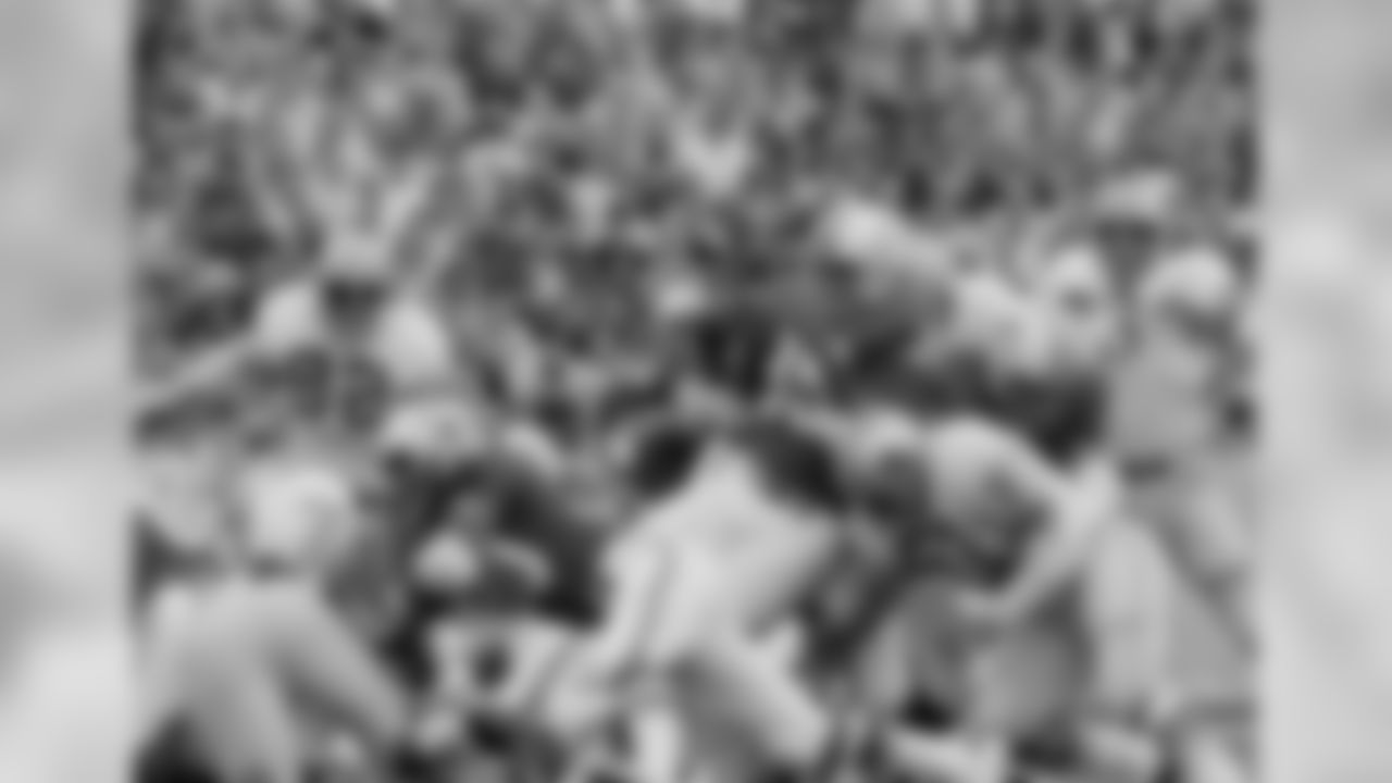 New England fullback Jim Nance (35) turns his back on the Detroit Lions defense in an attempt to back his way into a first down in the third period of their NFL game, Sunday, Sept. 26, 1971, Foxboro, Mass. Lions moving in on the play are Mike Lucci (53) and Jim Mitchell (83). The Lions won, 34-7. The rest of the players are unidentified. (AP Photo)