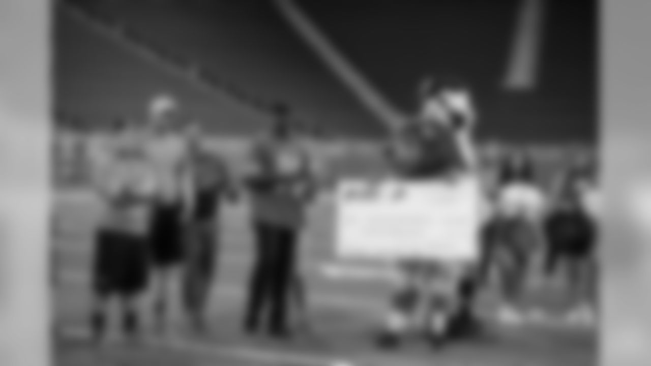 Roary presents a check to Loyola High School Football Team as part of Touchdown in Your Town on Thursday, June 27, 2019 in Detroit.
