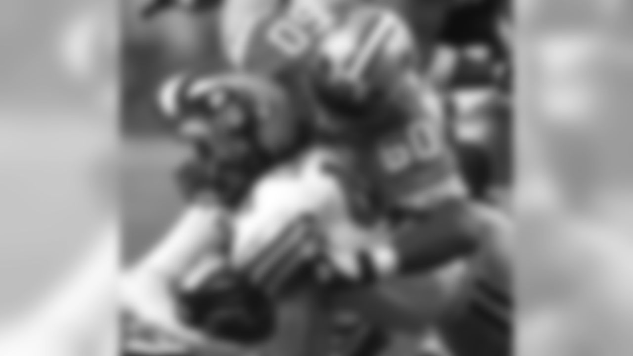 Detroit Lions middle linebacker Chris Claiborne (50) brings down Green Bay Packers running back Najeh Davenport in Detroit Sept. 20, 2002. (AP Photo/Paul Sancya)