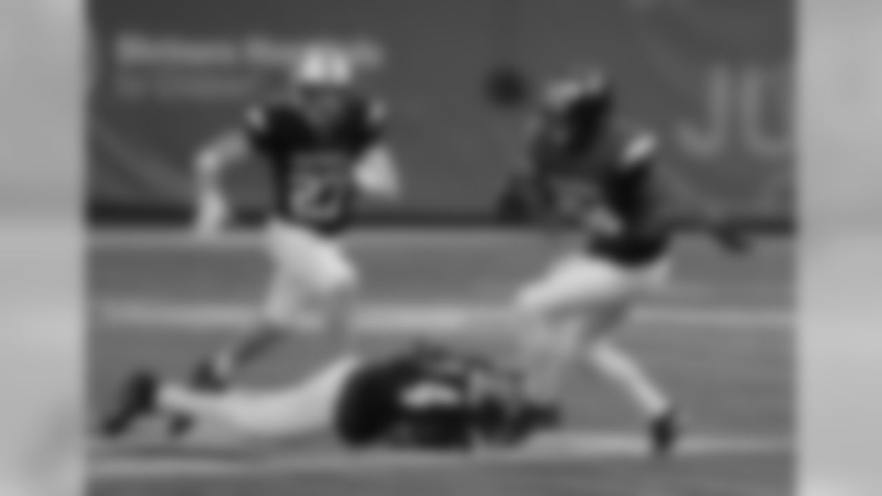 East running back Ty Johnson (24), of Maryland, gets tripped up by West safety Andrew Wingard (27), of Wyoming, and cornerback Mazzi Wilkins (14), of South Florida during the second half of the East West Shrine football game Saturday, Jan. 19, 2019, in St. Petersburg, Fla. (AP Photo/Chris O'Meara)