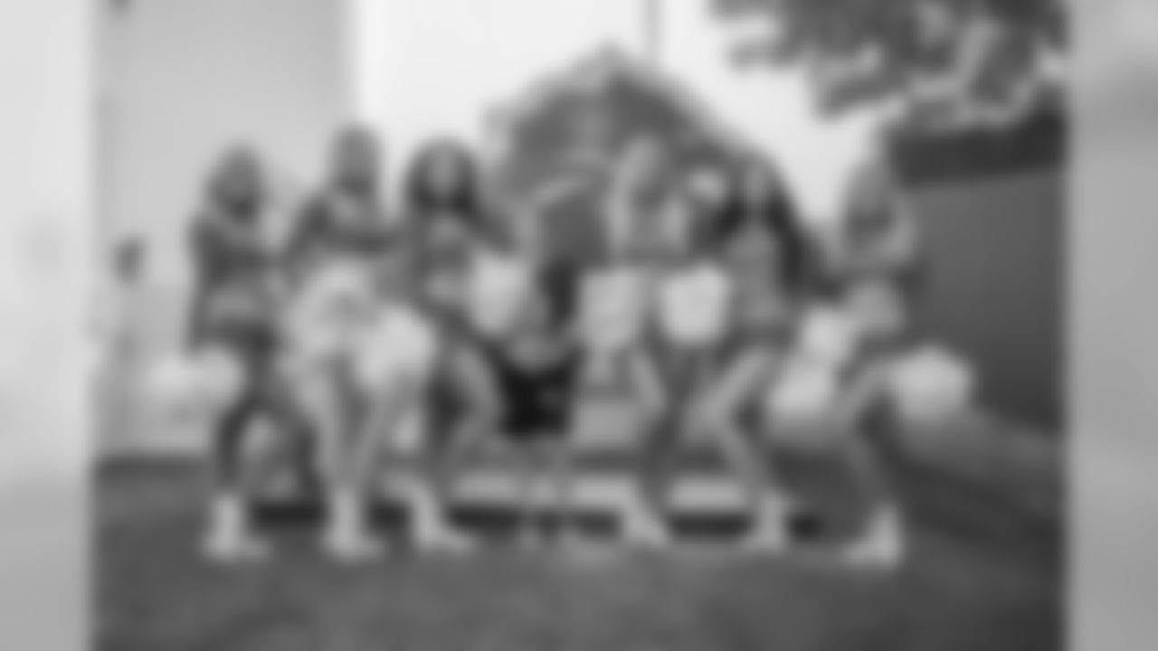 A fan poses for a photo with the Detroit Lions Cheerleaders before training camp practice on Thursday, Aug. 2, 2018 in Allen Park, Mich. (Detroit Lions via AP)