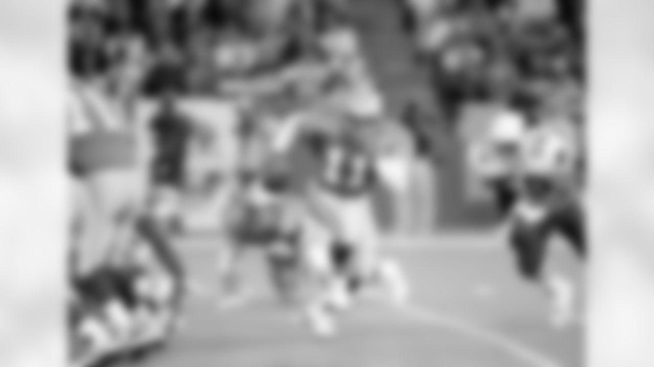 FILE - In this Sept. 26, 1993, file photo, Detroit Lions quarterback Andre Ware (11) runs from the pocket while trying to avoid the tackle of Phoenix Cardinals outside linebacker Freddie Joe Nunn (50) during the first quarter in Pontiac, Mich. The Motor City has witnessed a lot of losing seasons in the league in large part because the Lions have missed more than hit the mark with draft decisions. Taking quarterback Andre Ware seventh overall in 1990 is only one example. (AP Photo/Lennox McLendon, File)