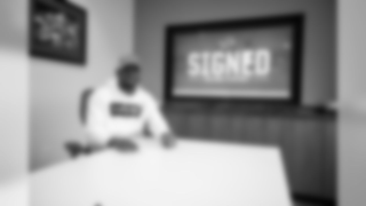 Detroit Lions cornerback Justin Coleman signs a free-agent contract at the Detroit Lions training facility on Thursday, March 14, 2019 in Allen Park, Mich. (Detroit Lions via AP)